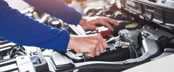 car-mechanic-with-wrench-on-car-in-garage